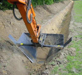 V Ditching Bucket in action cutting trench through ground