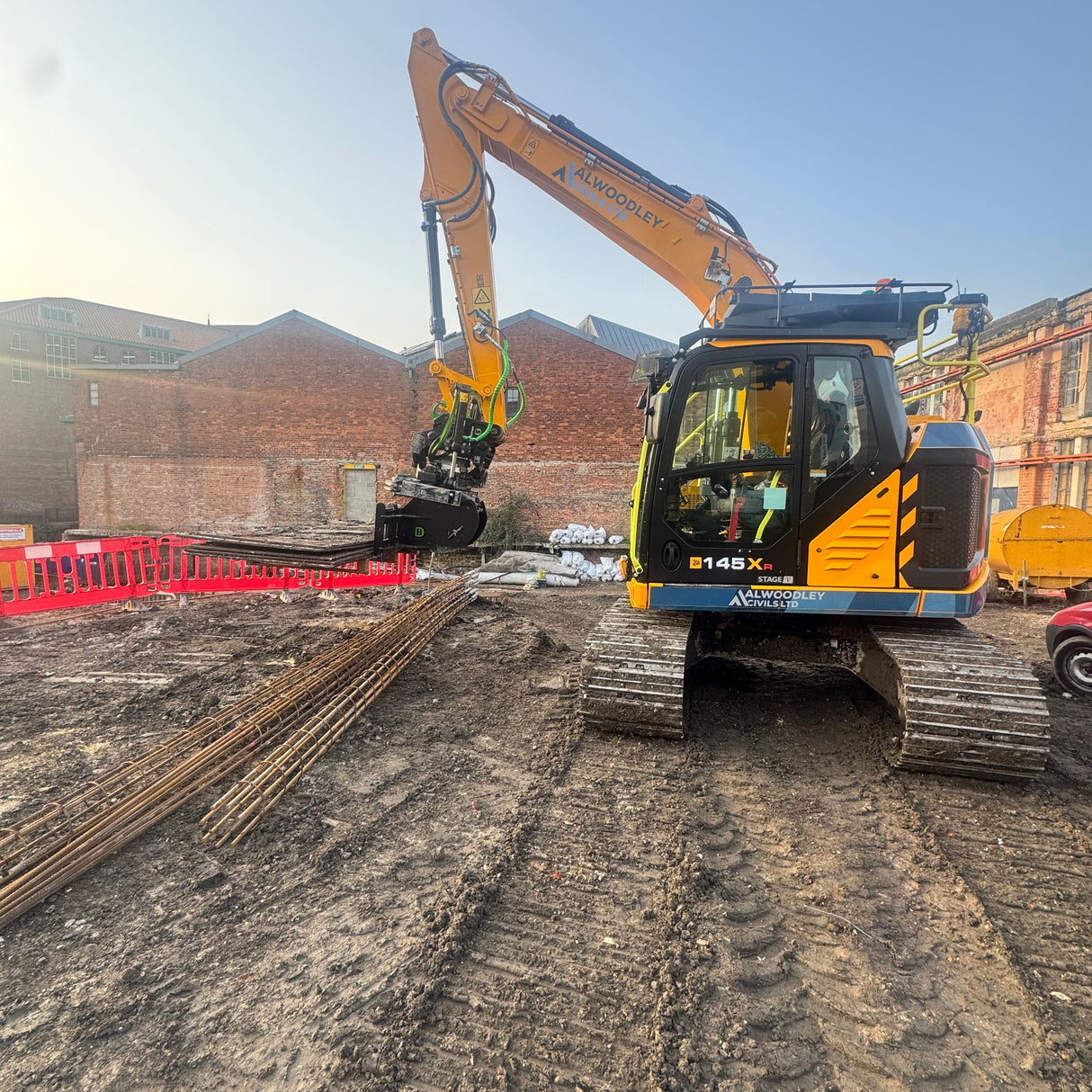 10-14 tonne Excavator with Pallet Forks on a construction site